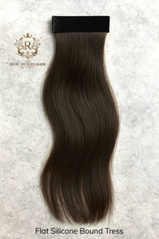 Brown human hair tress on a textured white background with 'Real Human Hair' branding.
