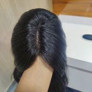 Close-up of a person holding an Indian hair wig
